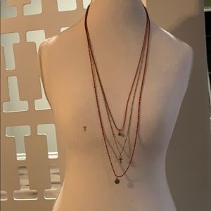 A super cute red with gold detailing necklace